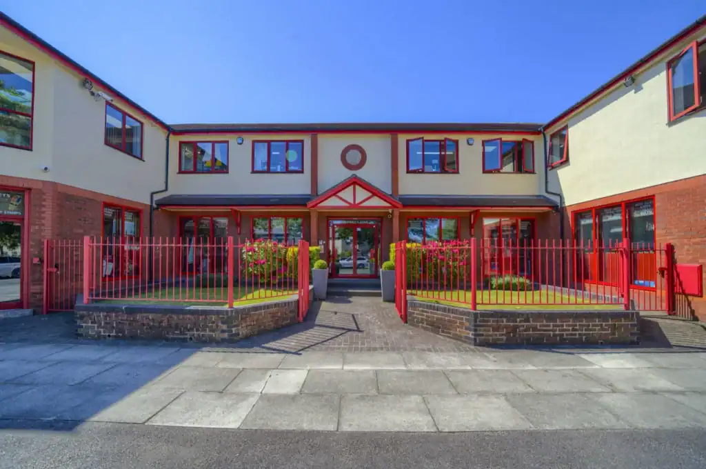 The W.R. Wright & Sons head office frontage, with red railings and planted beds