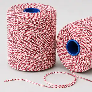 Two balls of red and white butchers string on blue plastic cores, one unwound