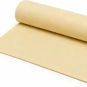 Sheet of pastry partly unrolled from a chilled pastry roll