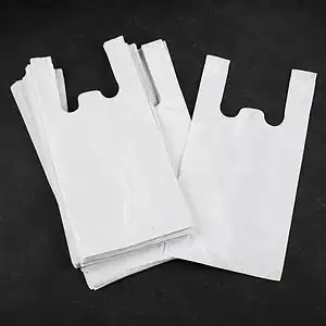 Plain white vest carrier bags, a single bag laid over a folded stack