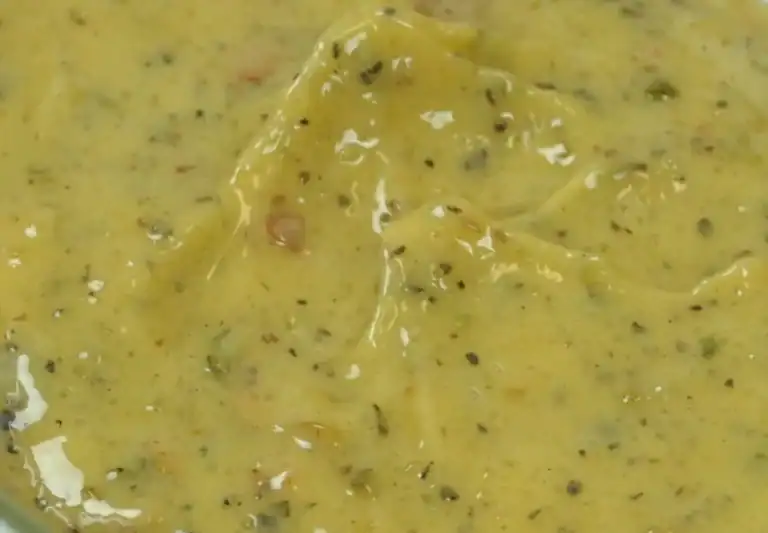 Close-up of RAPS Chinese Salt and Pepper marinade, a yellow paste flecked with black pepper and herbs