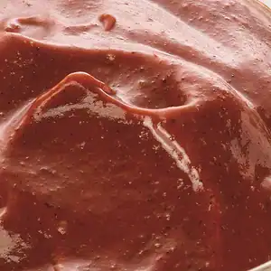 Close-up of RAPS Tandoori marinade, a deep red-brown spiced paste