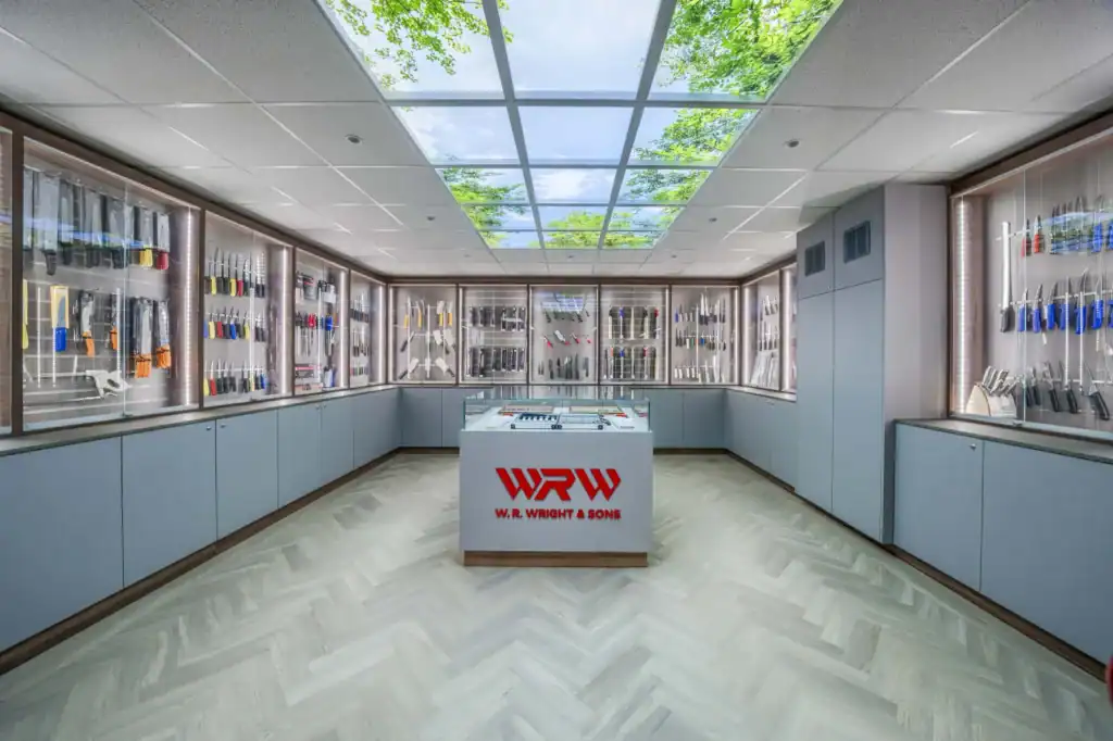 The W.R. Wright & Sons knife showroom, with the central display case under a glazed rooflight and knives in lit cabinets around it