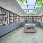 The W.R. Wright & Sons knife showroom, with the central display case under a glazed rooflight and knives in lit cabinets around it