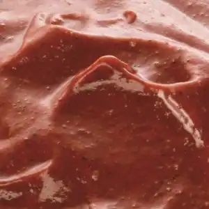 Close-up of RAPS Tandoori marinade, a deep red-brown spiced paste